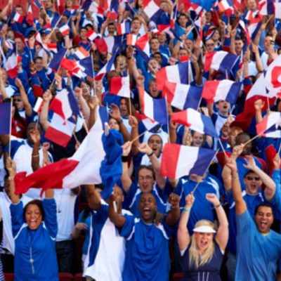 French crowd cheering and waving flags